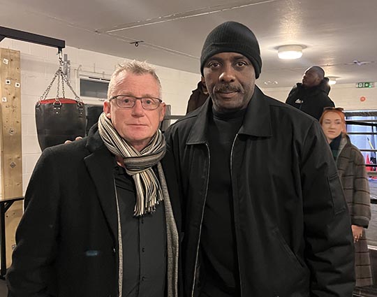 CEO, Patrick Green in a picture next to Idris Elba, actor and activist. Both are smiling and looking at the camera.